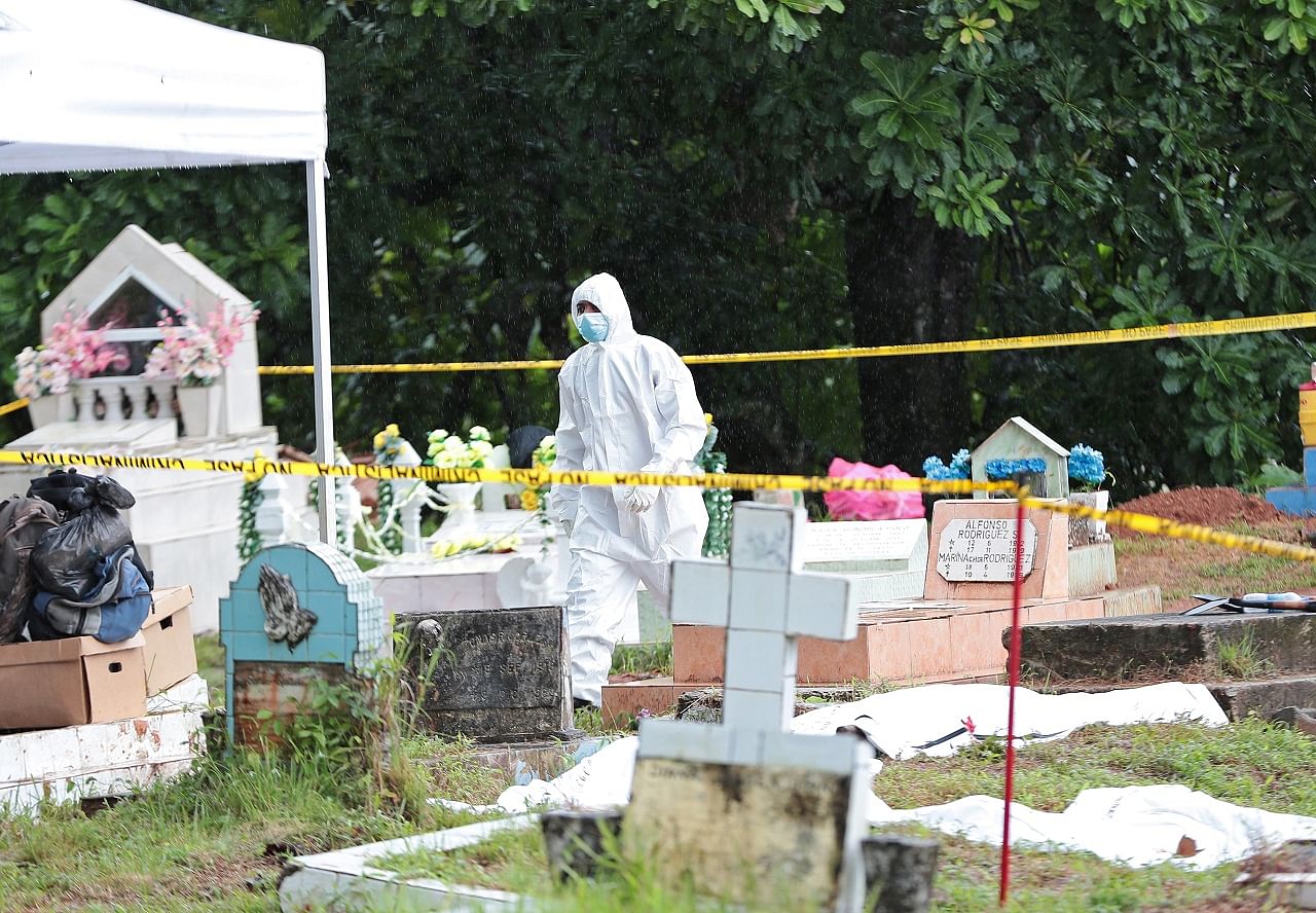 A member of a forensic team walks in the area during the exhumation of the remains of victims of the 1989 US invasion at the Monte Esperanza cemetery, in Colon. Credit: Reuters Photo