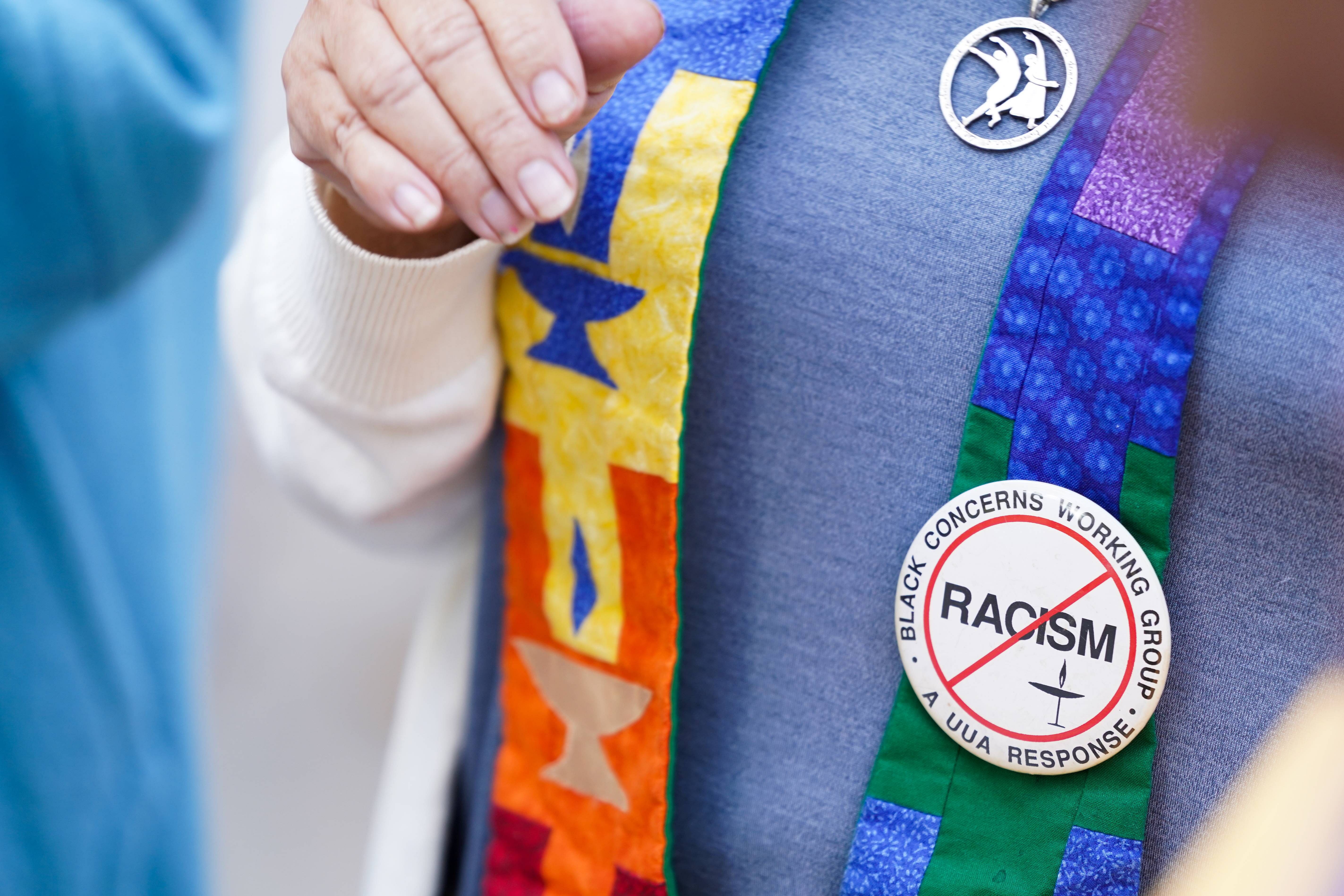 A religious leader wears an anti-racism button at the Glynn County Courthouse as jury selection begins in the trial of the defendants in the shooting death of Ahmaud Arbery. Credit: AFP Photo
