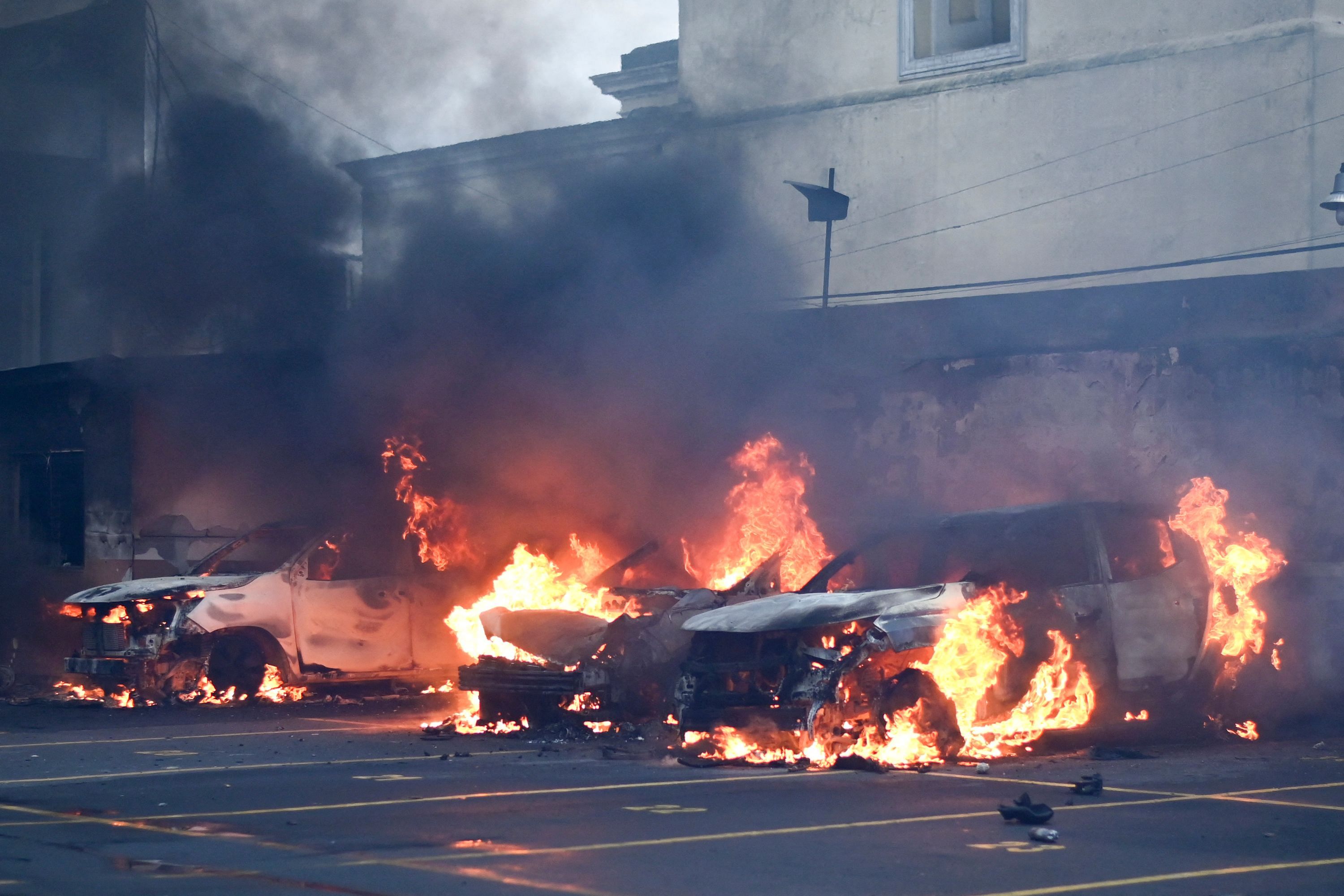 View of two burning two cars at the Congress' parking, set on fire by former Guatemalan soldiers protesting in demand of compensation for their services during the country civil war. Credit: AFP Photo