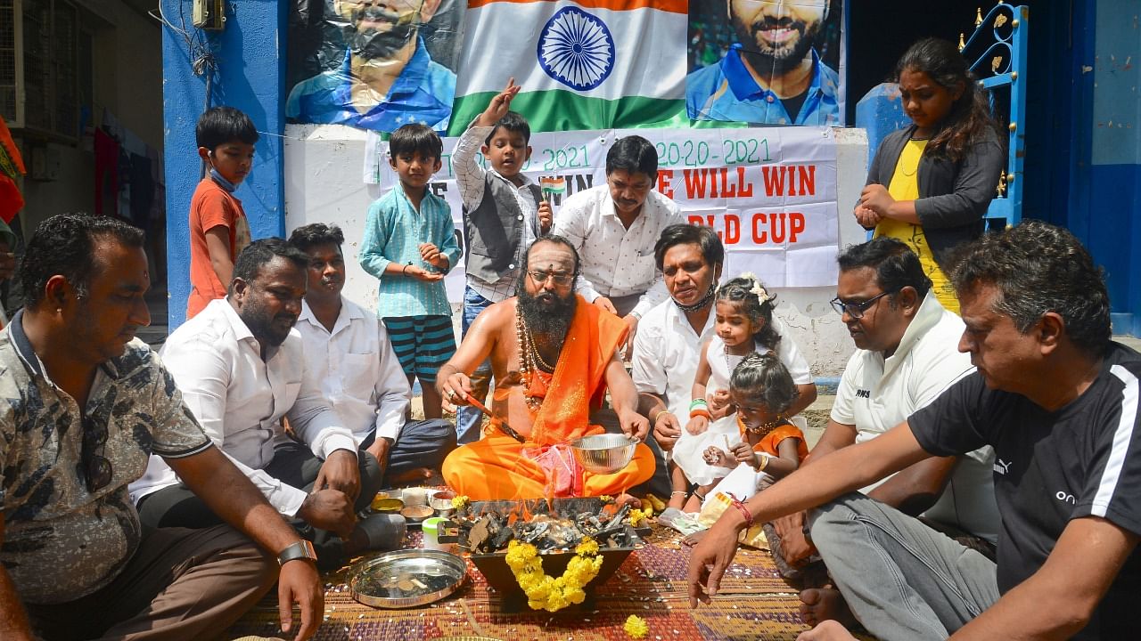 Indian cricket team fans perform 'havan' ahead of the T20 World Cup match against Pakistan, in Bengaluru. Arch-rivals India and Pakistan will renew their rivalry in the shortest form of cricket, as the two nations are set to clash in match 16 of the ICC Men’s T20 World Cup 2021 at Dubai International Cricket Stadium today.  Credit: PTI Photo