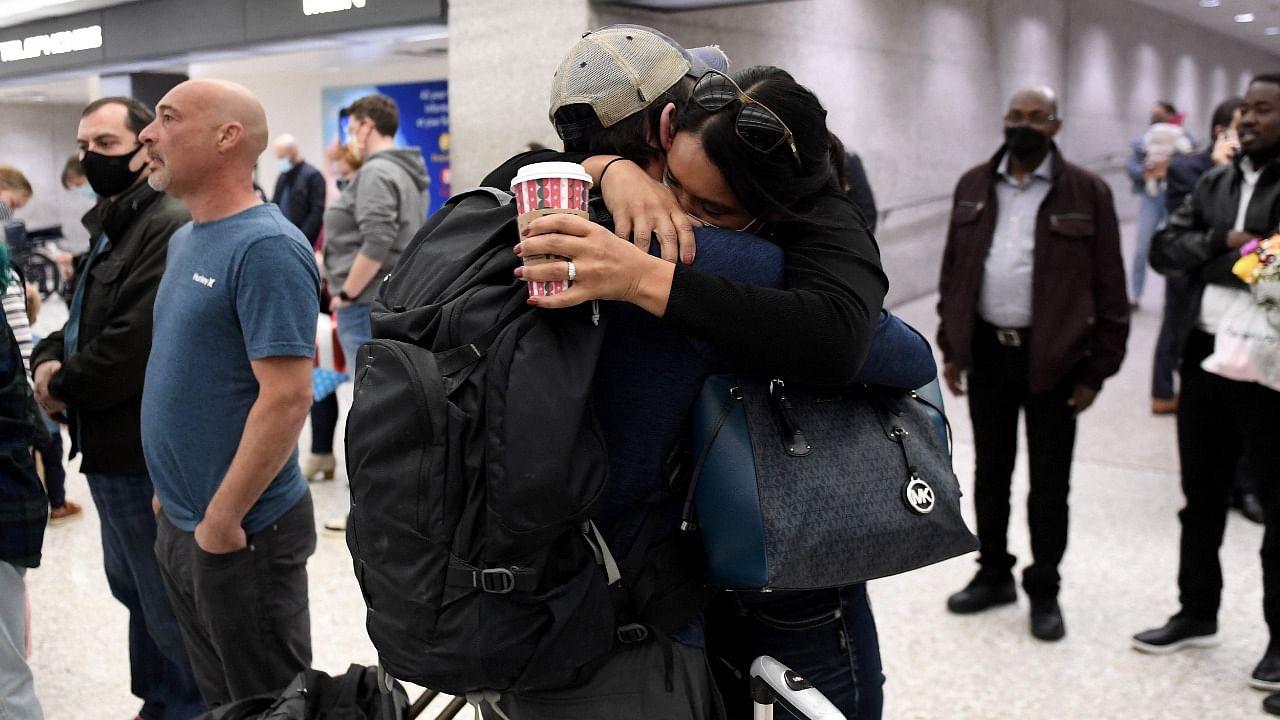Family members embrace each other as they are reunited upon arrival on a flight from Amsterdam as the US reopens air and land borders to vaccinated travellers for the first time since the Covid-19 restrictions were imposed, at Dulles International Airport in Chantilly, Virginia. Credit: AFP Photo