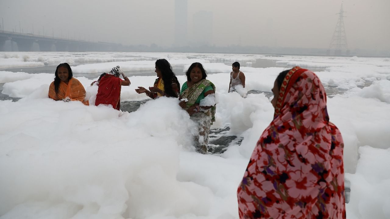 Chhath Puja: Devotees take a dip in Yamuna’s toxic foam