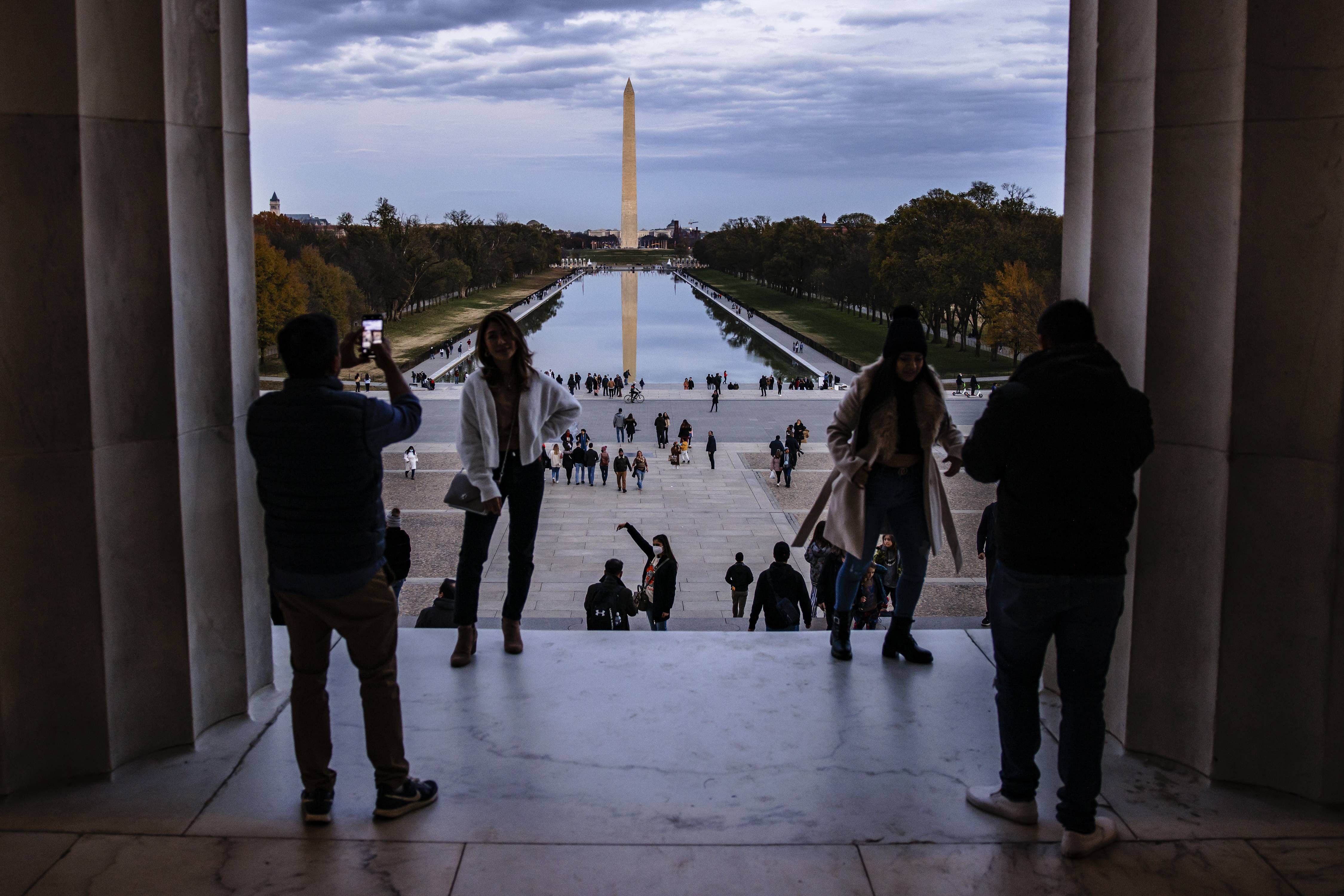 People look out towards the Washington Monument down the National Mall from the Lincoln Memorial. Credit: AFP Photo