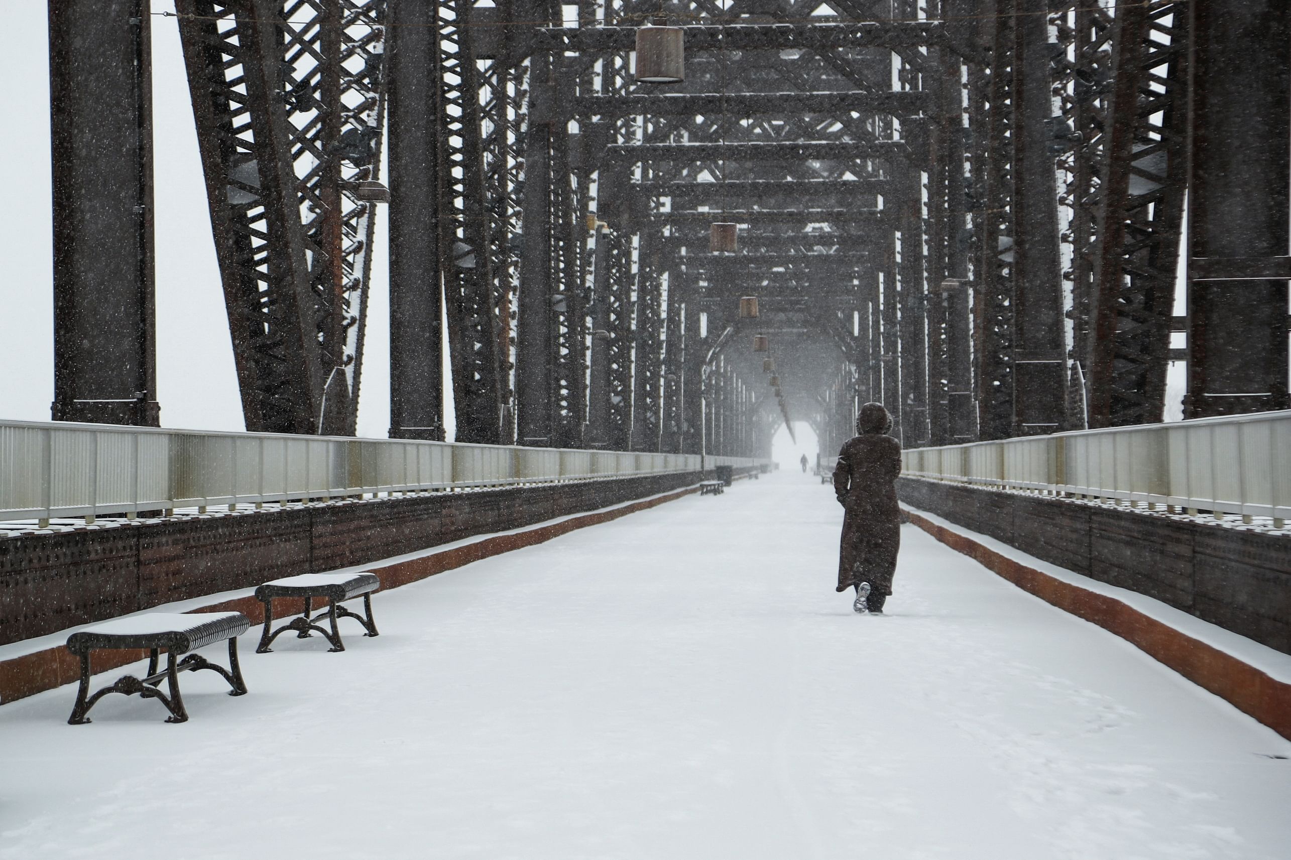 A woman walks on the Big Four Bridge during a snow storm in Louisville, Kentucky, US. Credit: Reuters Photo