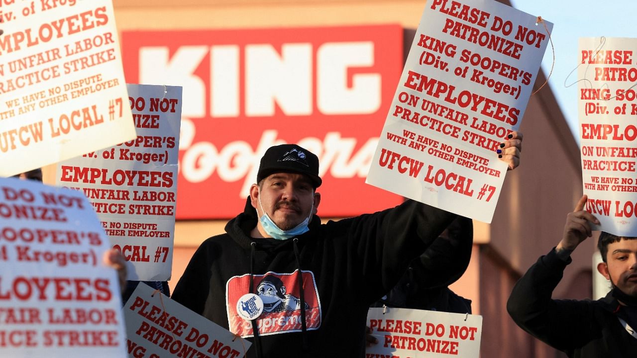 Union members raise signs outside a King Soopers store during a protest as workers go on strike in Denver, Colorado. Credit: Reuters Photo