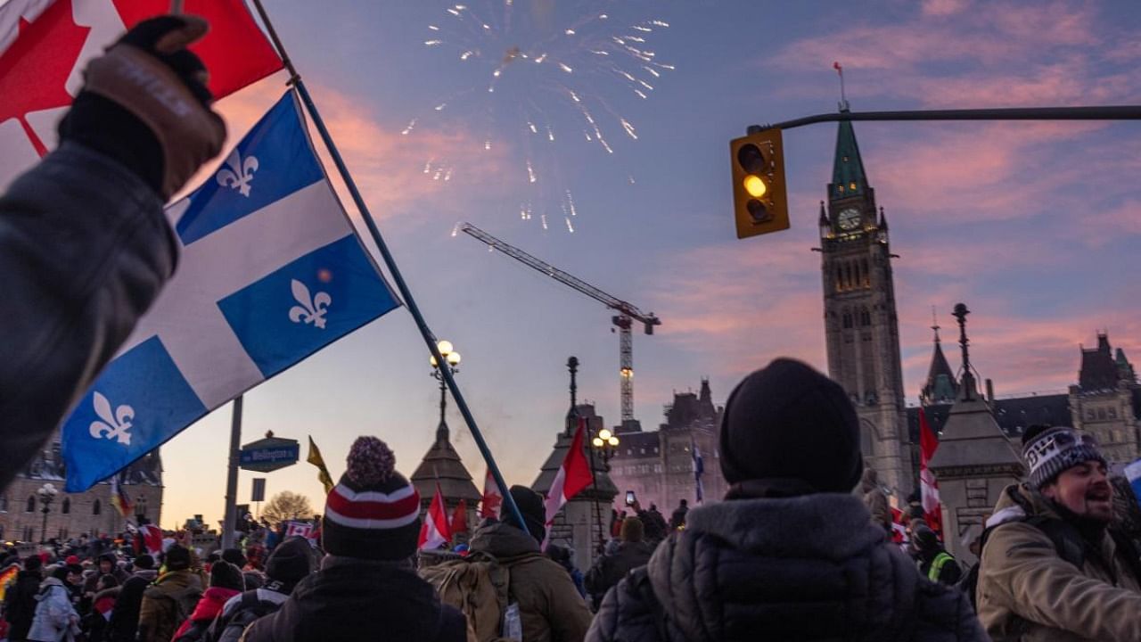 Fireworks explode over a crowd of protestors during a rally against Covid-19 vaccine mandates on Parliament Hill on January 29, 2022 in Ottawa. Credit: AFP Photo