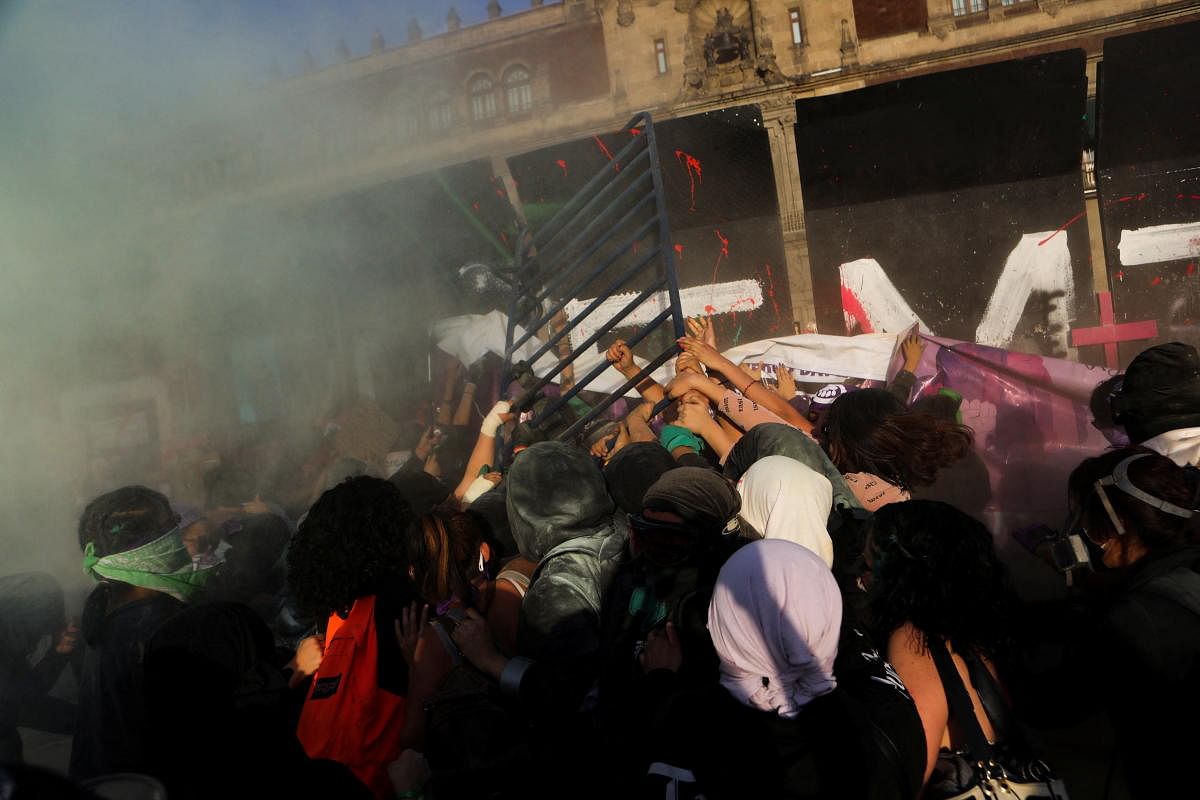 Women use a fence to hit a fence protecting the National Palace during a protest to mark International Women's Day, in Mexico City, Mexico. Credit: Reuters Photo