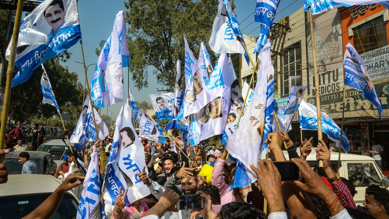 AAP supporters celebrate as early trends favour party in Punjab. Credit: PTI Photo