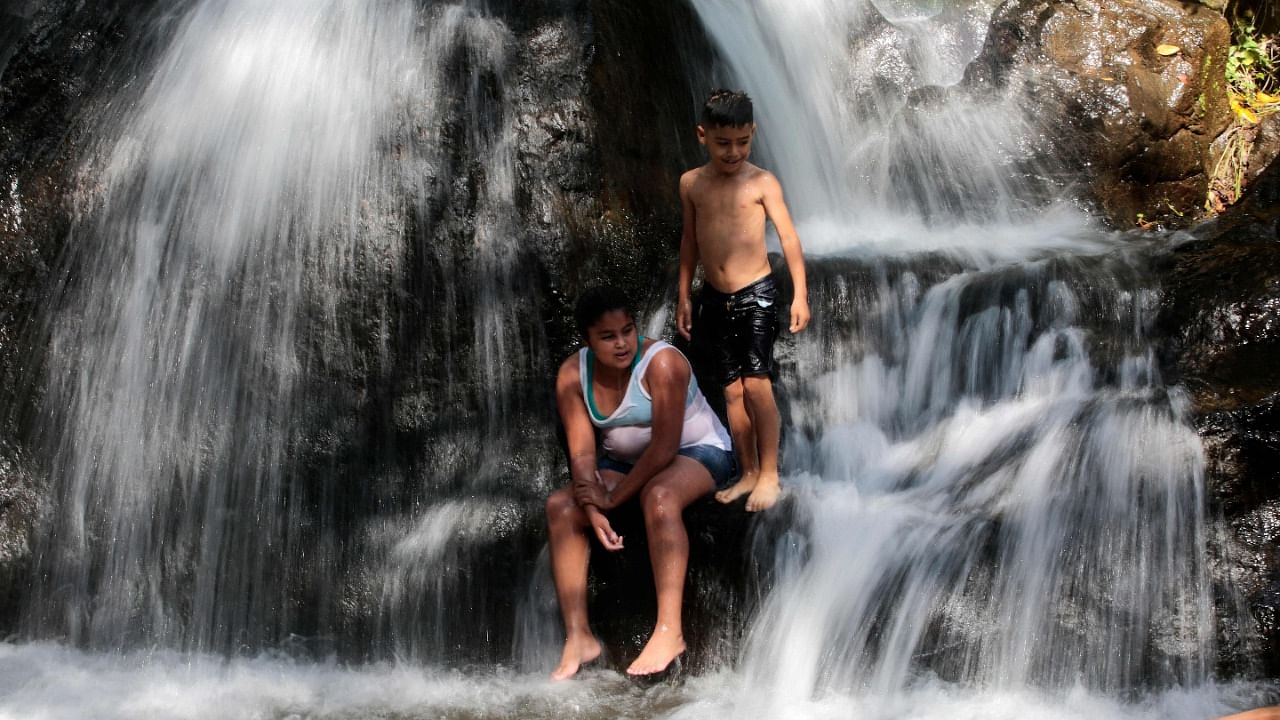 Children cool off under the El Salto waterfall in San Rafael del Sur, Managua department, Nicaragua. Credit: AFP Photo