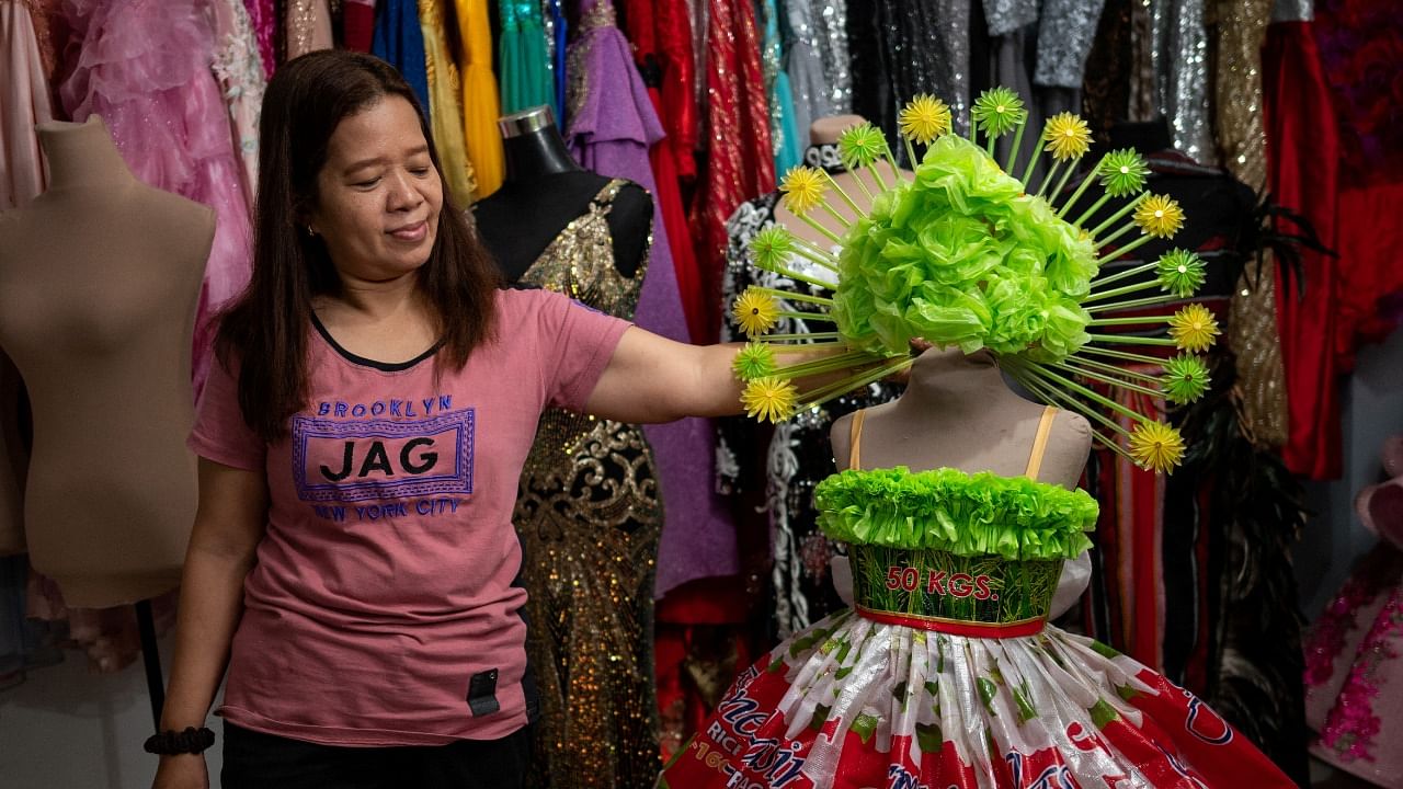 materials, in Cainta Nora Buenviaje shows an outfit made of recycled sacks of rice, plastic bags and straws, at her shop in Cainta, Rizal Province, Philippines. Credit: Reuters Photo