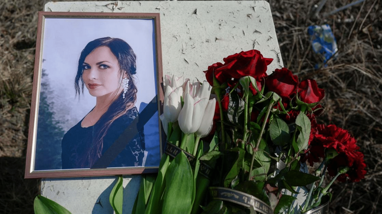  A portrait of a young woman who died during a Russian attack is pictured with flowers next to her fresh grave in the cemetery of in Mykolaiv, southern Ukraine. Credit: AFP Photo