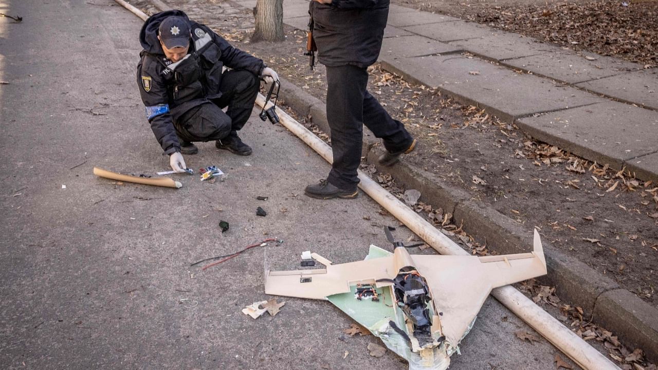  Ukrainian police officers inspect a downed Russian drone in the area of a research institute, part of Ukraine's National Academy of Science, after a strike, in northwestern Kyiv. Credit: AFP Photo