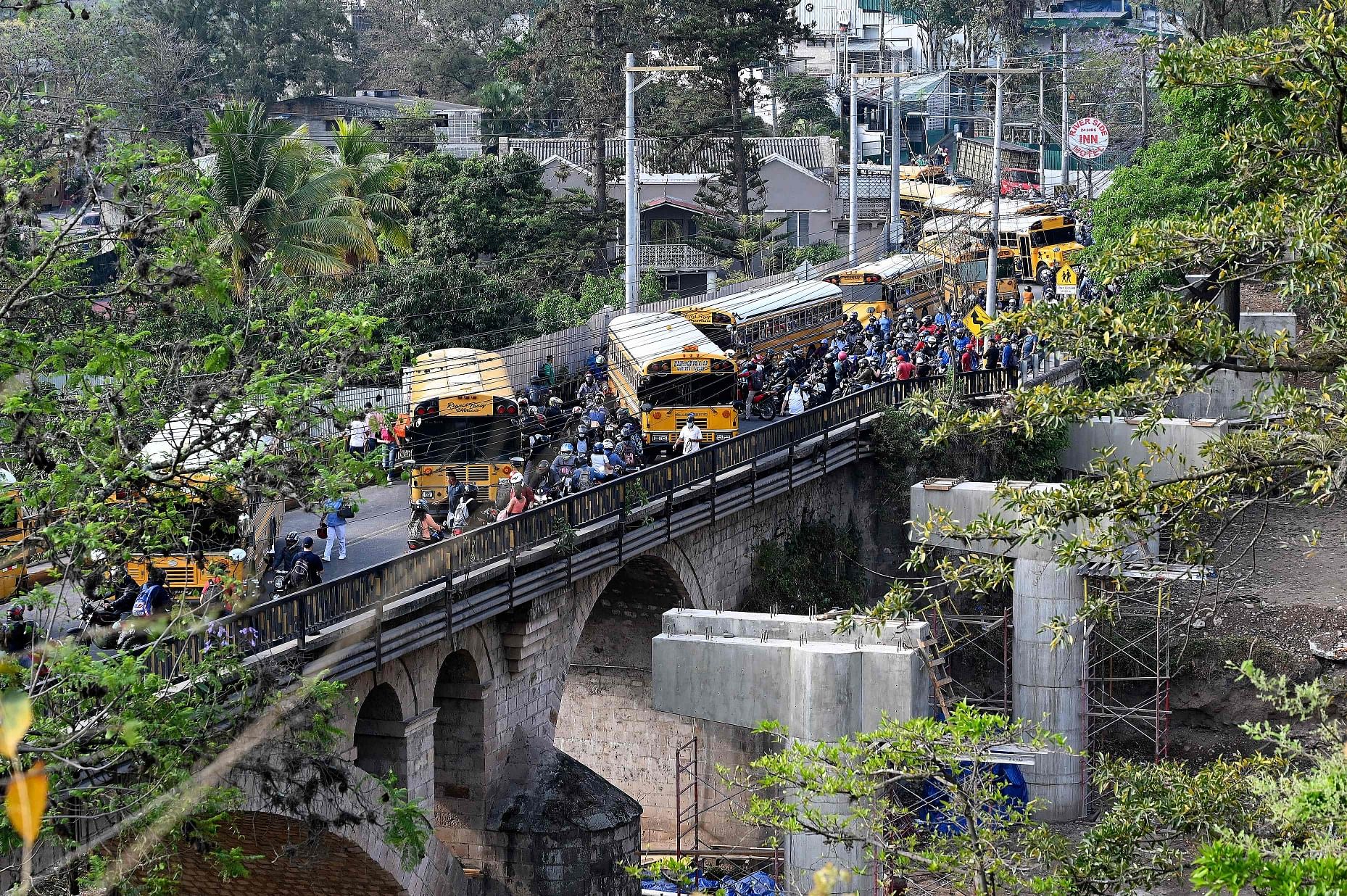 Public transport buses remain on the Germania bridge during a national transport strike for the high price of oil derivates, in the southern outskirts of Tegucigalpa. Credit: AFP Photo