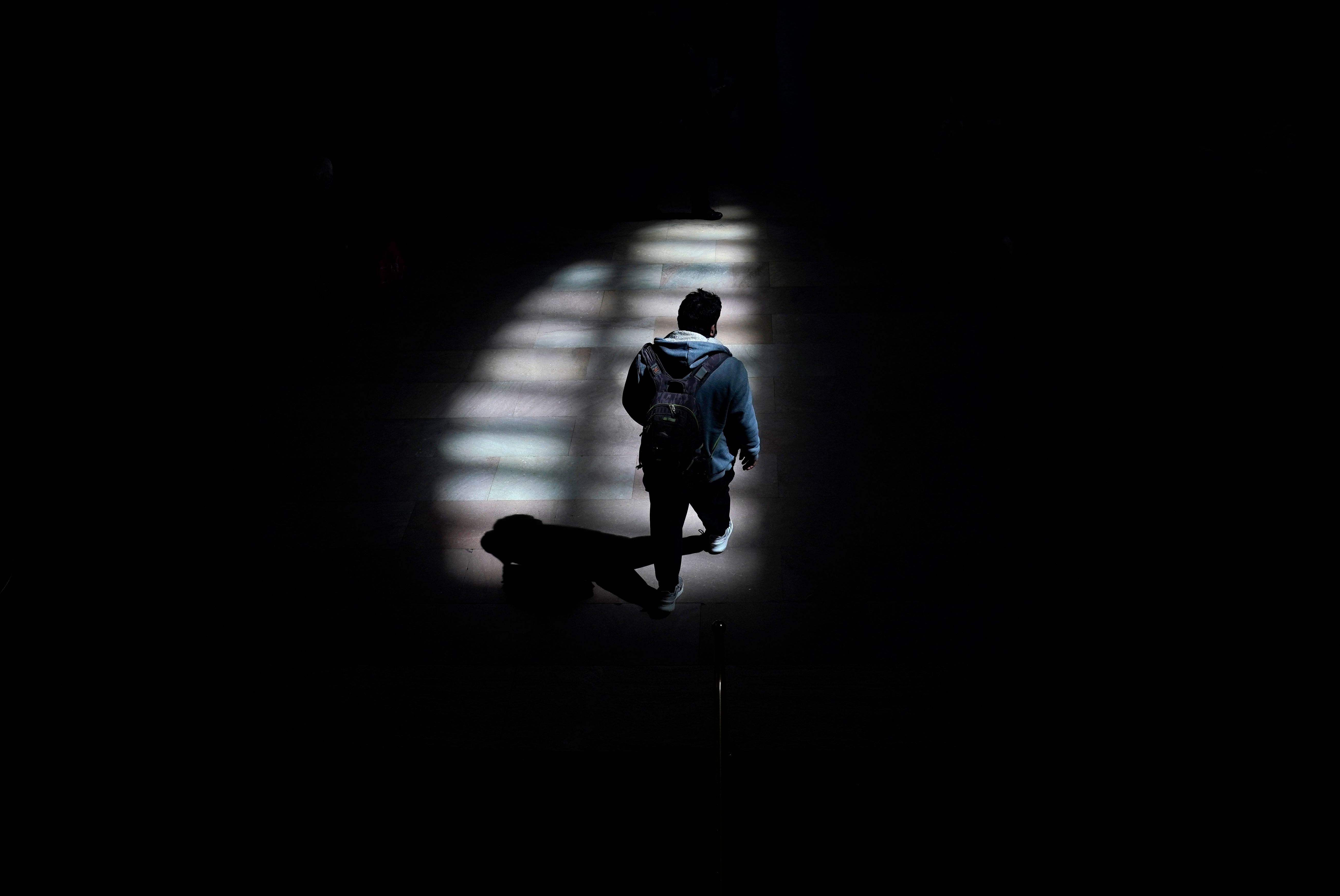 A man walks through the afternoon shadows at Grand Central Terminal in New York City. Credit: AFP Photo