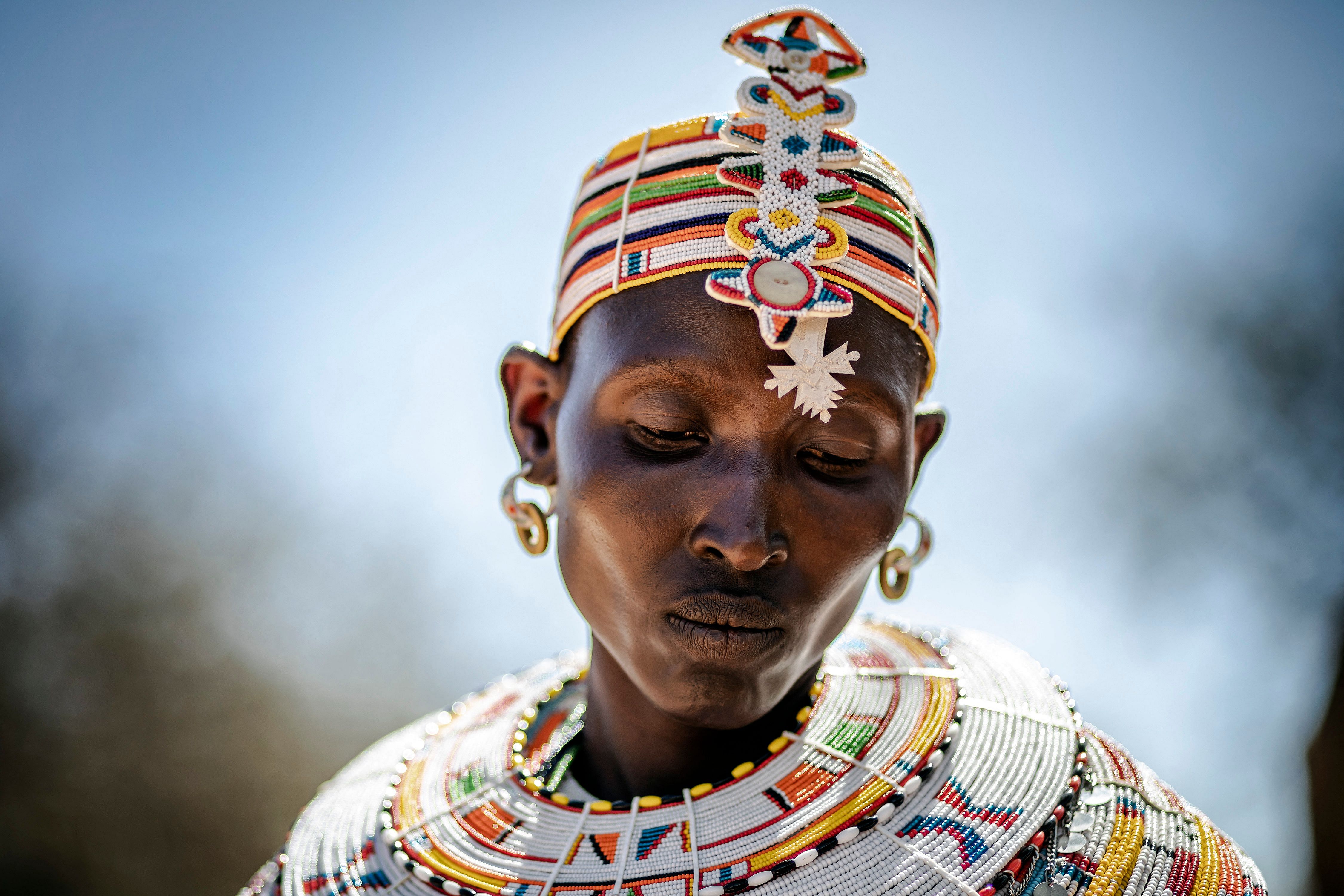Bariti Leorto, a Samburu woman, works making traditional Samburu ornaments and jewelry out of beads next to a house in Kalama Conservancy, Samburu County, Kenya. Credit: AFP Photo