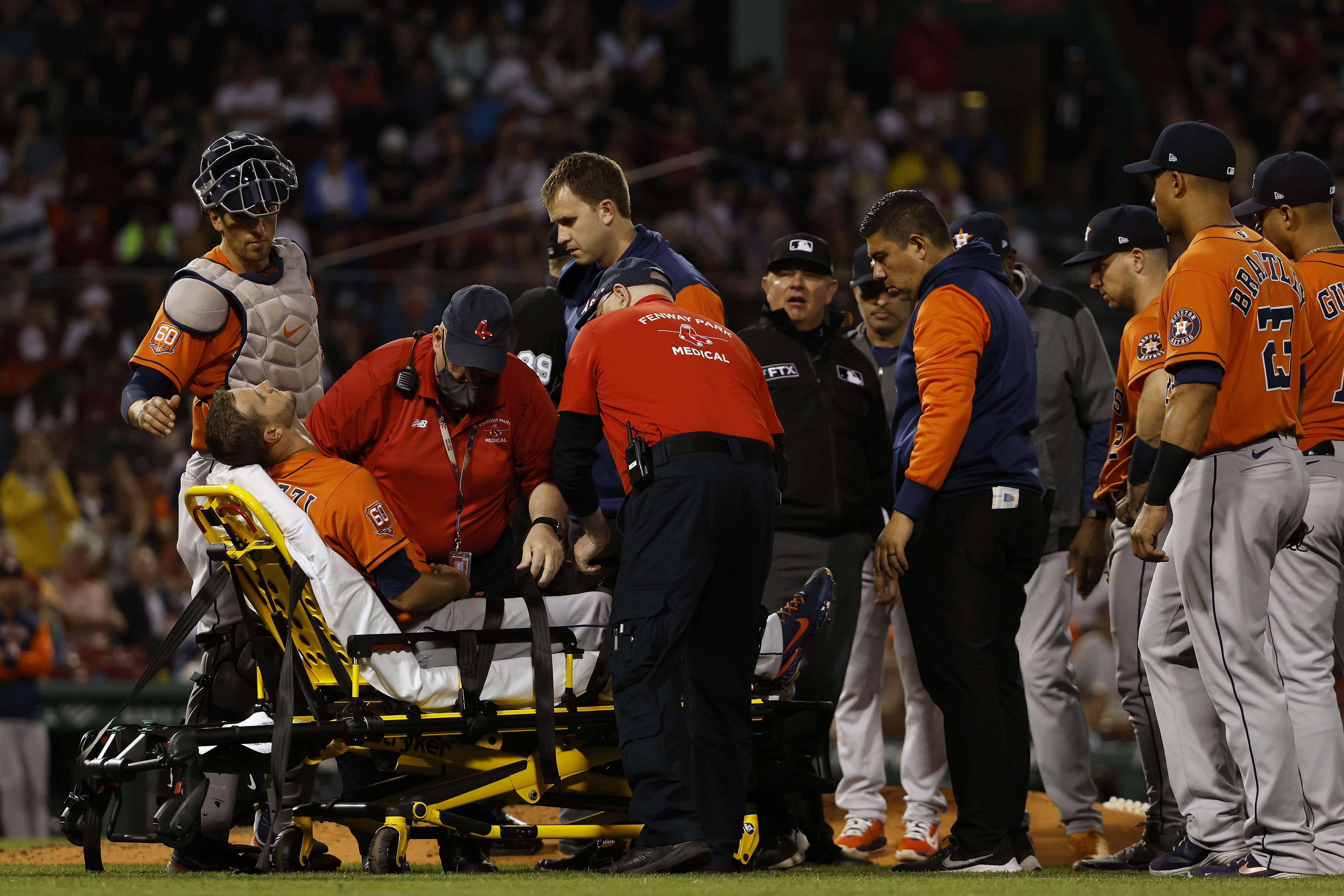 Pitcher Jake Odorizzi #17 of the Houston Astros is buckled onto a stretcher after being injured trying to get off the mound to cover first base on a ground out by Enrique Hernandez of the Boston Red Sox during the sixth inning at Fenway Park. Credit: AFP Photo