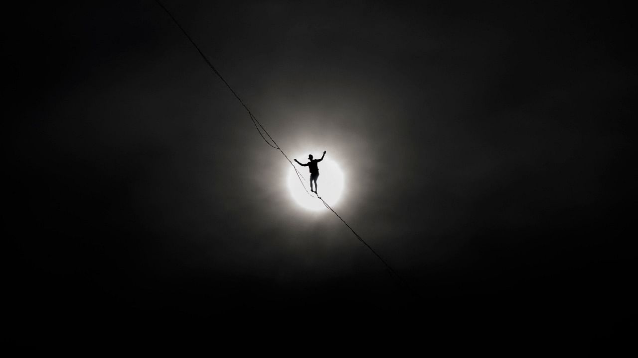  French tightrope walker Nathan Paulin walks on a 950 meters long slackline, 50 meters over Geneva Lake between the right and left banks of the city of Geneva during an event part of the Swiss National Day. Credit: AFP Photo