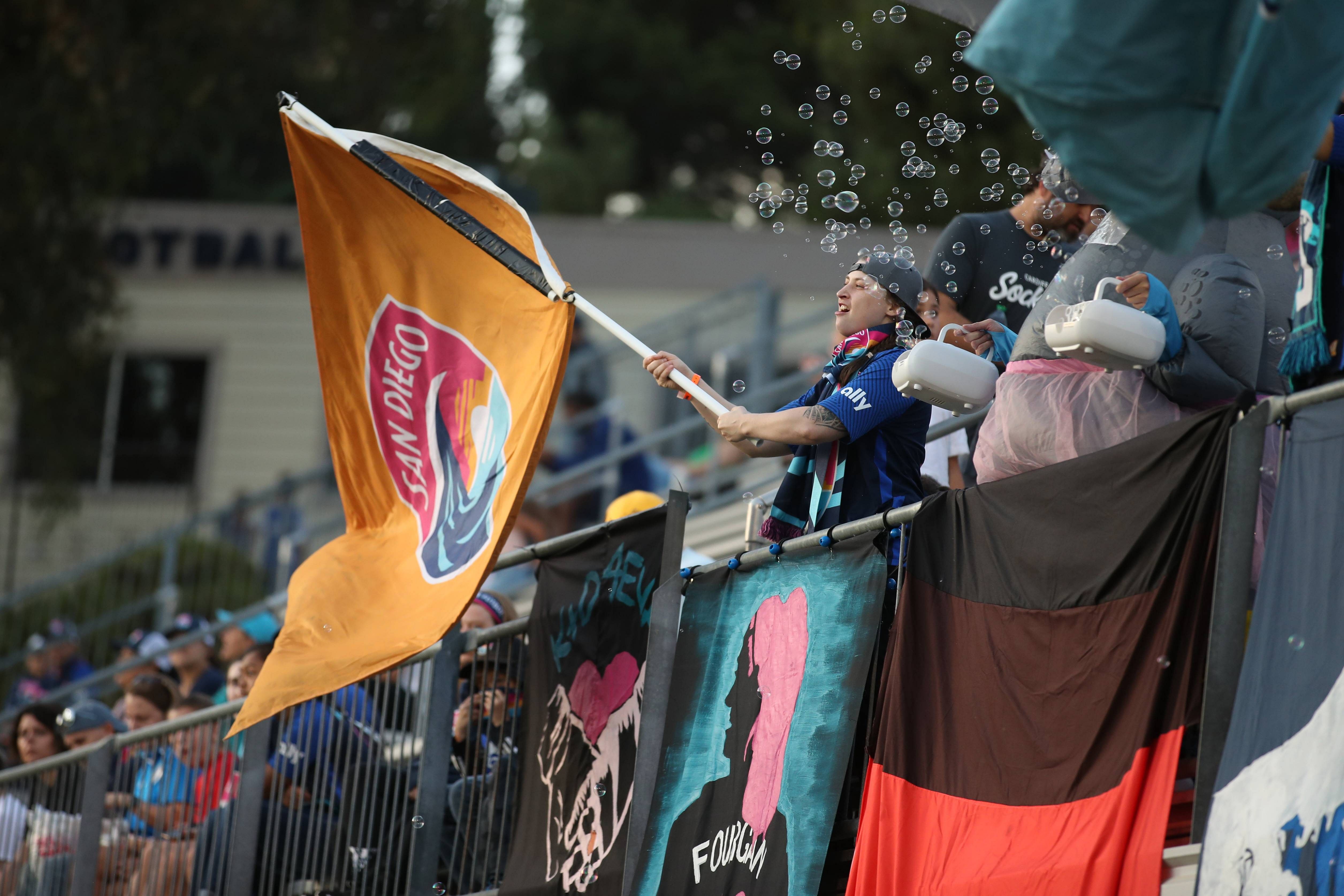 A fan waves a San Diego Wave FC flag prior to the match against Orlando Pride at Torero Stadium on August 13, 2022 in San Diego. Credit: Reuters Photo