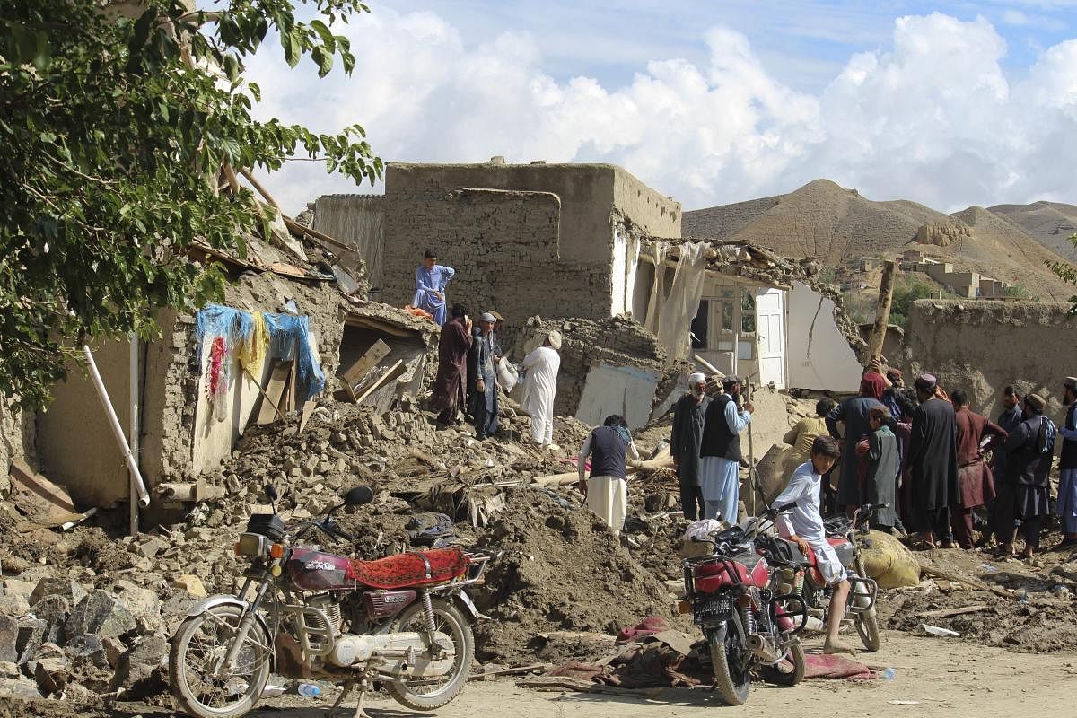 People clean up their damaged homes after heavy flooding in the Khushi district of Logar province south of Kabul, Afghanistan. Credit: AP Photo