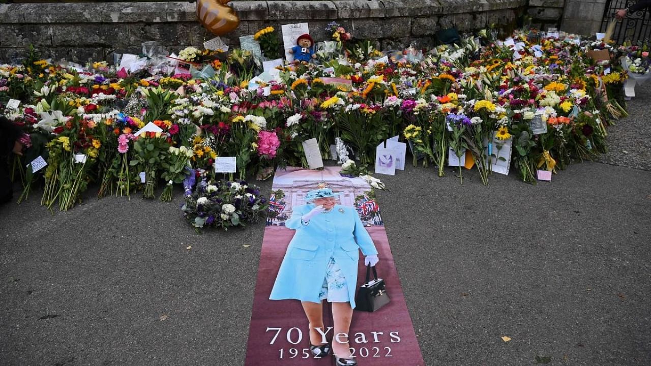 Flowers and tributes are pictured outside of Balmoral Castle in Ballater, on September 9, 2022, a day after Queen Elizabeth II died at the age of 96. Credit: AFP Photo