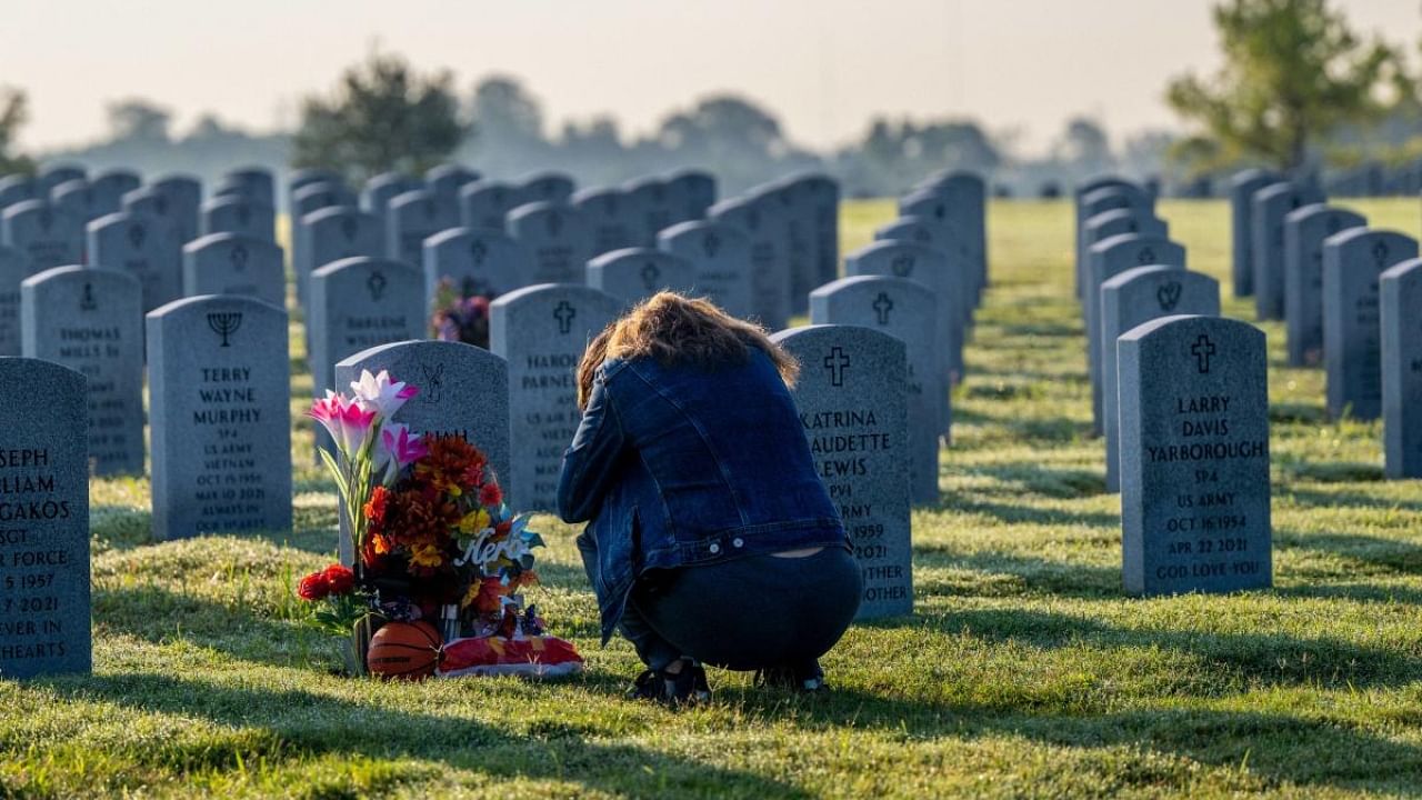 Elena Ramos pays her respects to her brother, Senior airman Elijah Reyes Posana, at the Houston National Cemetery on September 10, 2022 in Houston, Texas. People around Houston have begun visiting and preparing ahead of the 21st anniversary of the 9/11 terrorist attacks in New York City. Credit: AFP Photo