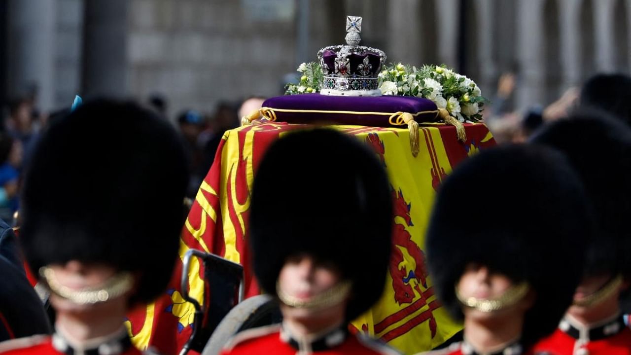 The Imperial State Crown is seen on the coffin of Queen Elizabeth II, adorned with a Royal Standard and the Imperial State Crown and pulled by a Gun Carriage of The King's Troop Royal Horse Artillery, during a procession from Buckingham Palace to the Palace of Westminster, in London. Credit: AFP Photo