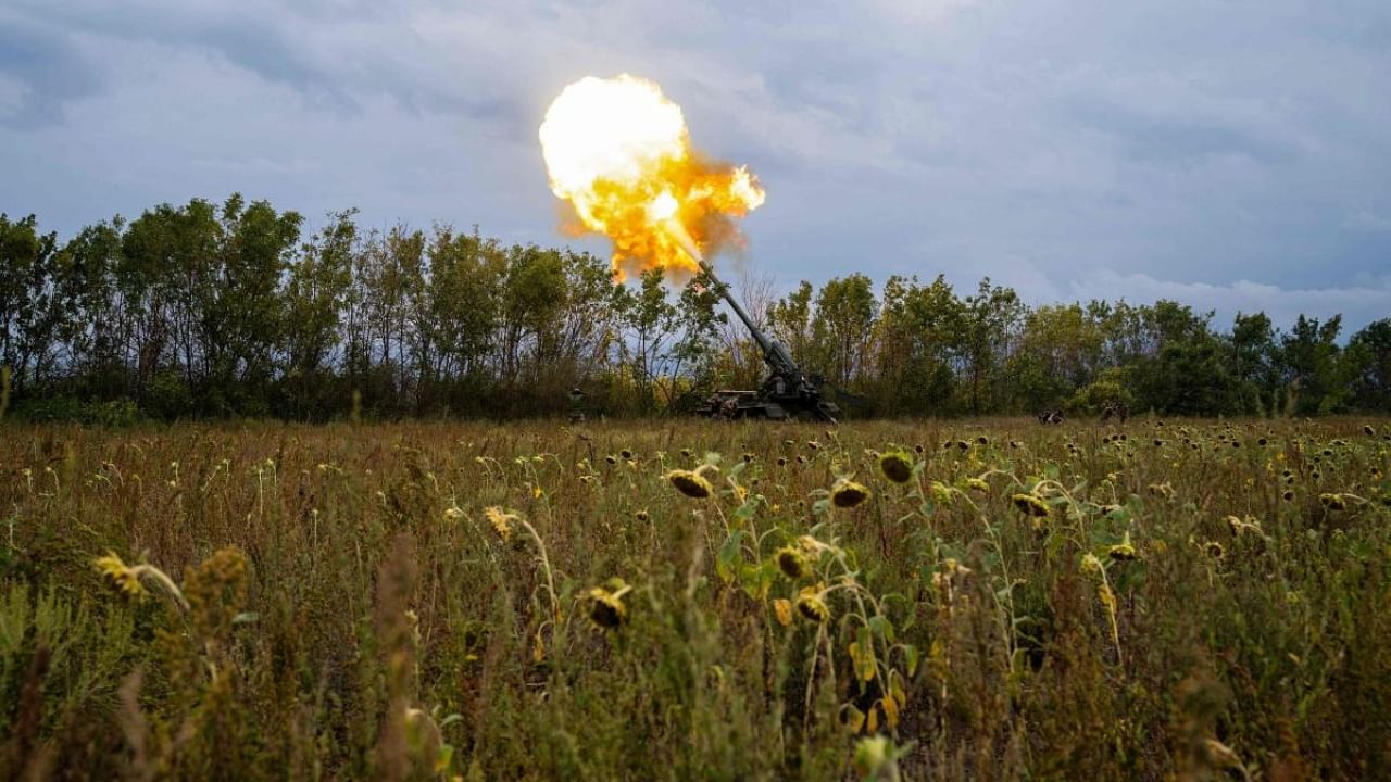 Ukrainian artillerymen fire a self-propelled 203mm cannon "2s7 Pion" at a sunflowers field on the southern frontline of Ukraine. Credit: AFP Photo