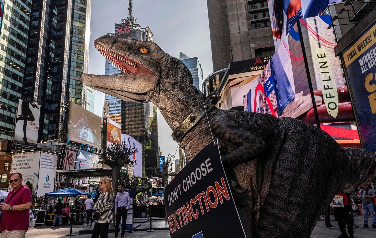 Frankie the Dinosaur, mascot of the United Nations Development Program "Don’t Choose Extinction" visits Times Square spreading his climate-related message in New York. Credit: AFP Photo