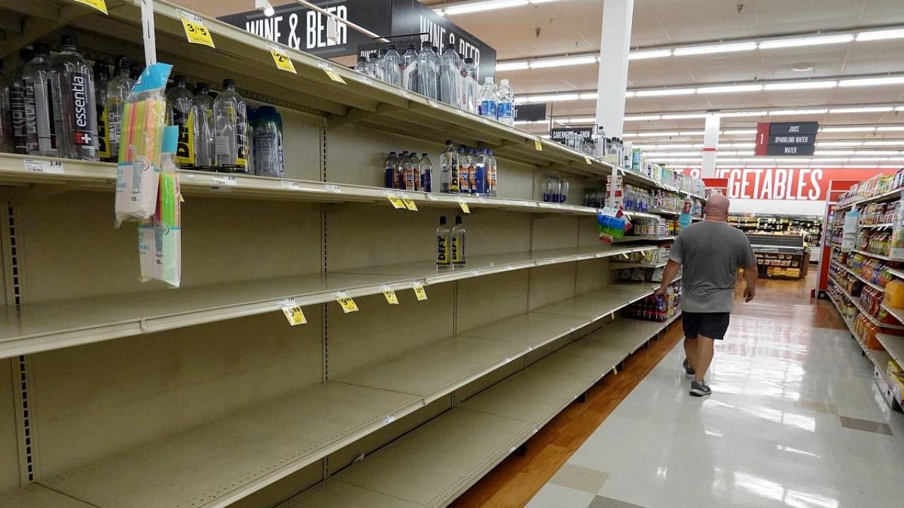 A person stands in an empty water aisle in a grocery store as people stock up on necessary items in prepartation for the possible arrival of Hurricane Ian on September 26, 2022 in St Petersburg, Florida. Credit: AFP Photo