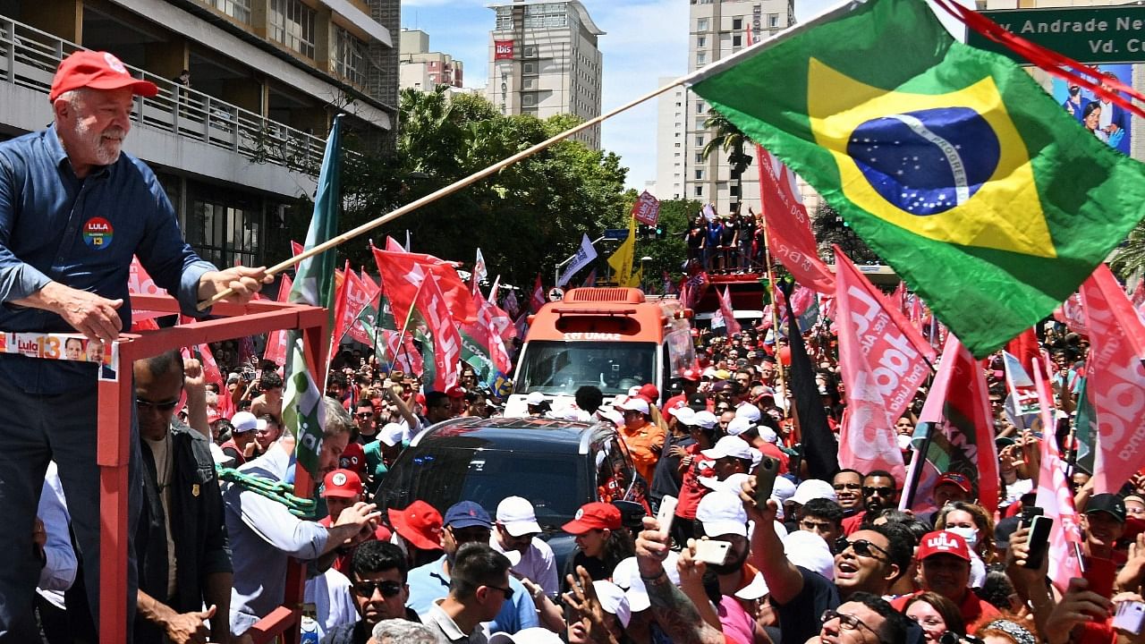 Brazil's former President (2003-2010) and presidential candidate for the leftist Workers Party (PT) Luiz Inacio Lula da Silva (L) greets supporters during a campaign rally in Campinas, Sao Paulo state, Brazil. Credit: AFP Photo