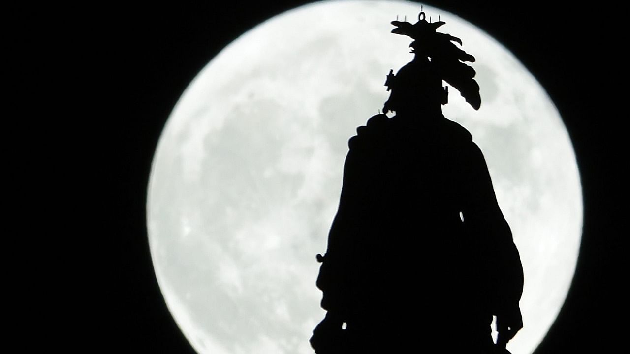  The Hunter’s Moon rises behind The Statue of Freedom that crowns the U.S. Capitol dome on October 9, 2022 in Washington, DC. The Hunter’s Moon historically signaled the time for hunting with brighter moon light in preparation for the upcoming cold winter. Credit: AFP Photo