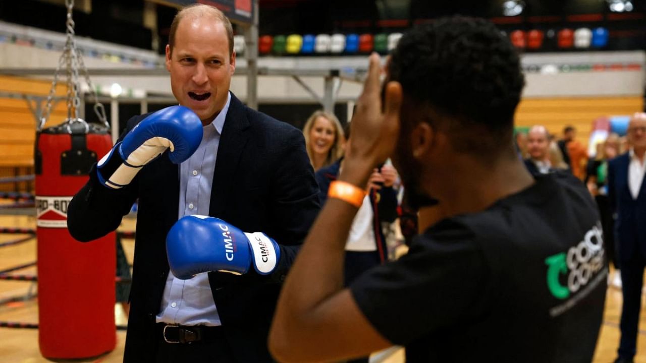 Britain's William (L), Prince of Wales, trains in boxing gloves during a visit to Copper Box Arena to celebrate the 10th anniversary of Coach Core in London on October 13, 2022. Credit: AFP Photo