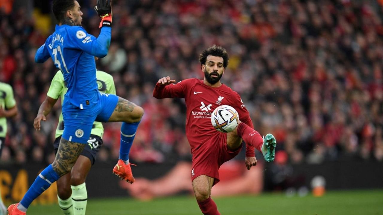 Liverpool's Egyptian striker Mohamed Salah (R) vies with Manchester City's Brazilian goalkeeper Ederson (L) during the English Premier League football match between Liverpool and Manchester City at Anfield in Liverpool. Credit: AFP Photo