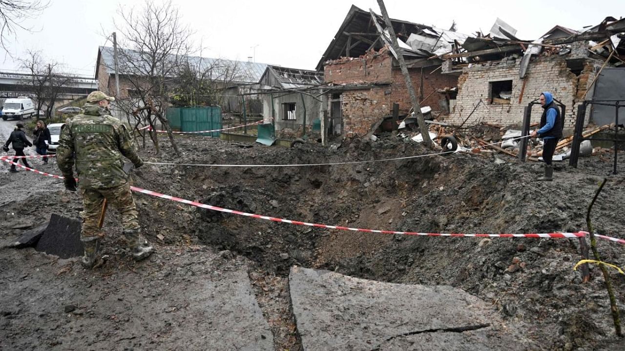 Police experts examine a crater after a missile strike in a village, near the western Ukrainian city of Lviv, on November 16, 2022, amid the Russian invasion of Ukraine. Credit: AFP Photo