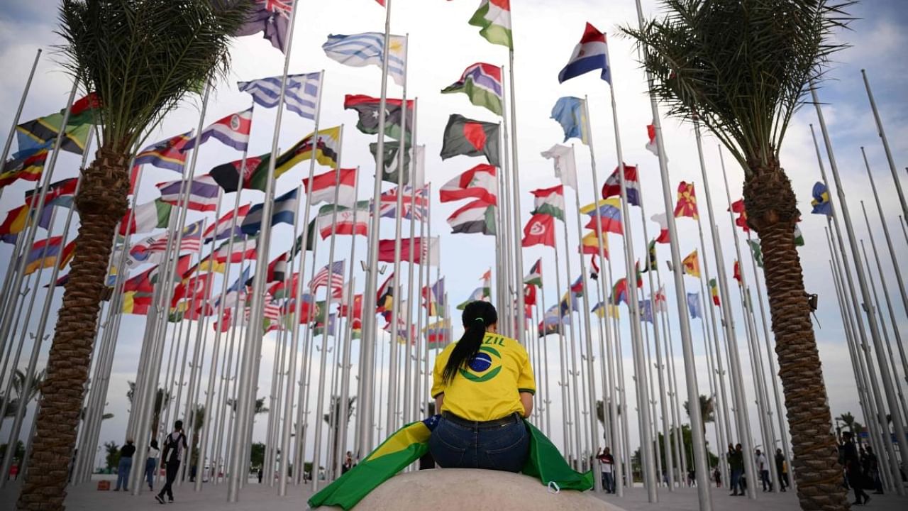 A woman seats at Flags square, in Doha on November 17, 2022, ahead of the Qatar 2022 World Cup football tournament. Credit: AFP Photo