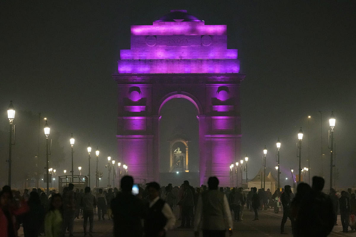 India Gate lit up in purple to mark the International Day of Persons with Disabilities. Credit: PTI Photo