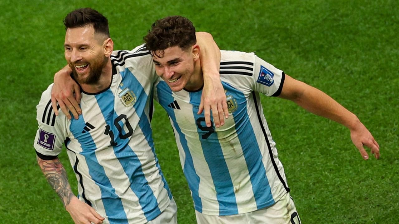 Argentina's forward #09 Julian Alvarez celebrates with Argentina's forward #10 Lionel Messi (L) after scoring his team's second goal during the Qatar 2022 World Cup football semi-final match between Argentina and Croatia. Credit: AFP Photo