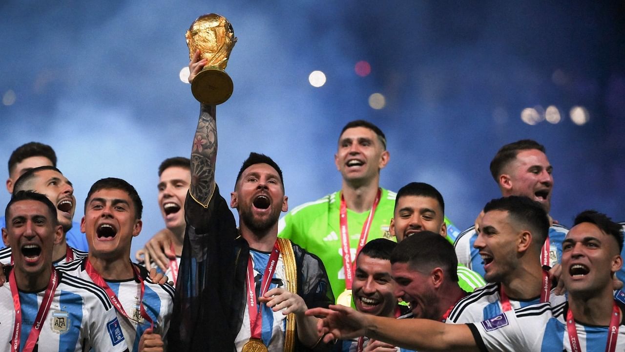 Argentina's forward #10 Lionel Messi lifts the World Cup trophy during the Qatar 2022 World Cup trophy ceremony after the football final match between Argentina and France at Lusail Stadium in Lusail, north of Doha on December 18, 2022. Credit: AFP Photo