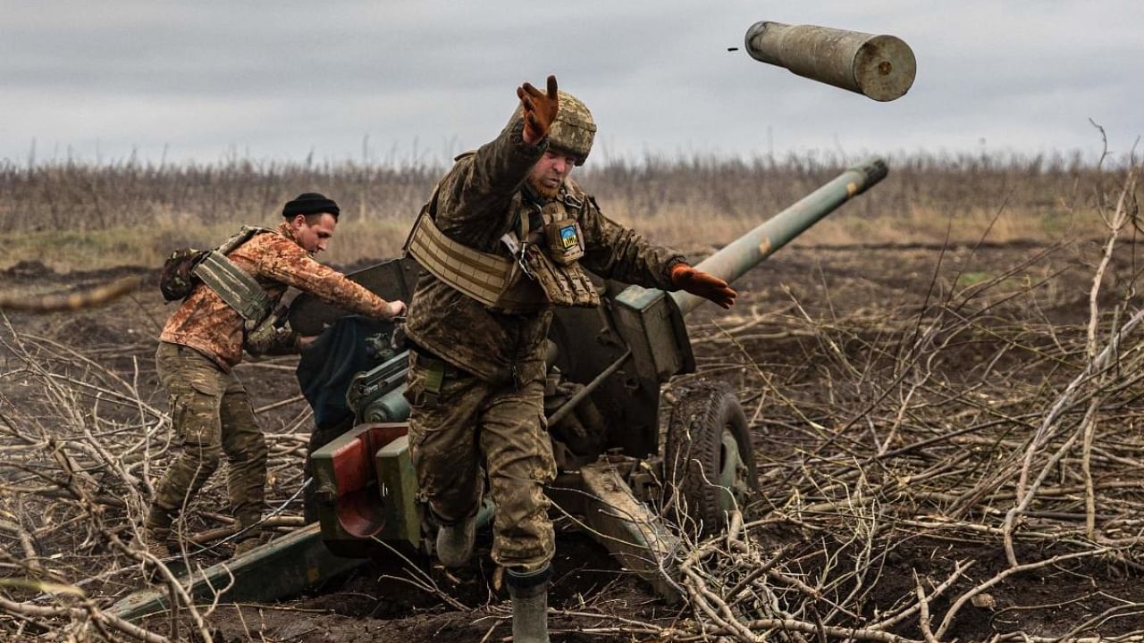 A Ukrainian serviceman of an artillery unit throws an empty shell as they fire towards Russian positions on the outskirts of Bakhmut, eastern Ukraine on December 30, 2022.  Credit: AFP Photo