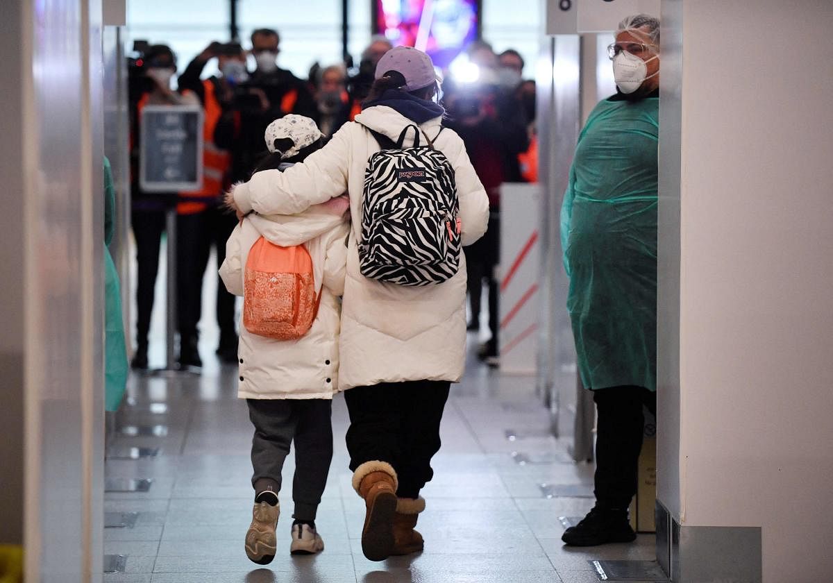 Passengers of a flight from China walks through the Covid-19 testing booths at the Paris-Charles-de-Gaulle airport in Roissy, outside Paris as France reinforces health measures at the borders for travellers arriving from China. Credit: AFP Photo