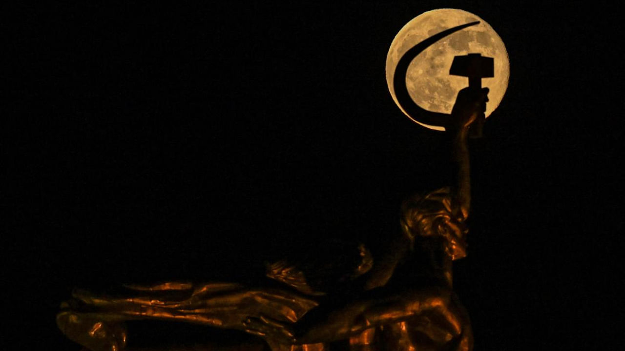 The full moon also known as Wolf moon behind the sculpture of "Worker and Kolkhoz Woman" in Moscow. Credit: AFP Photo