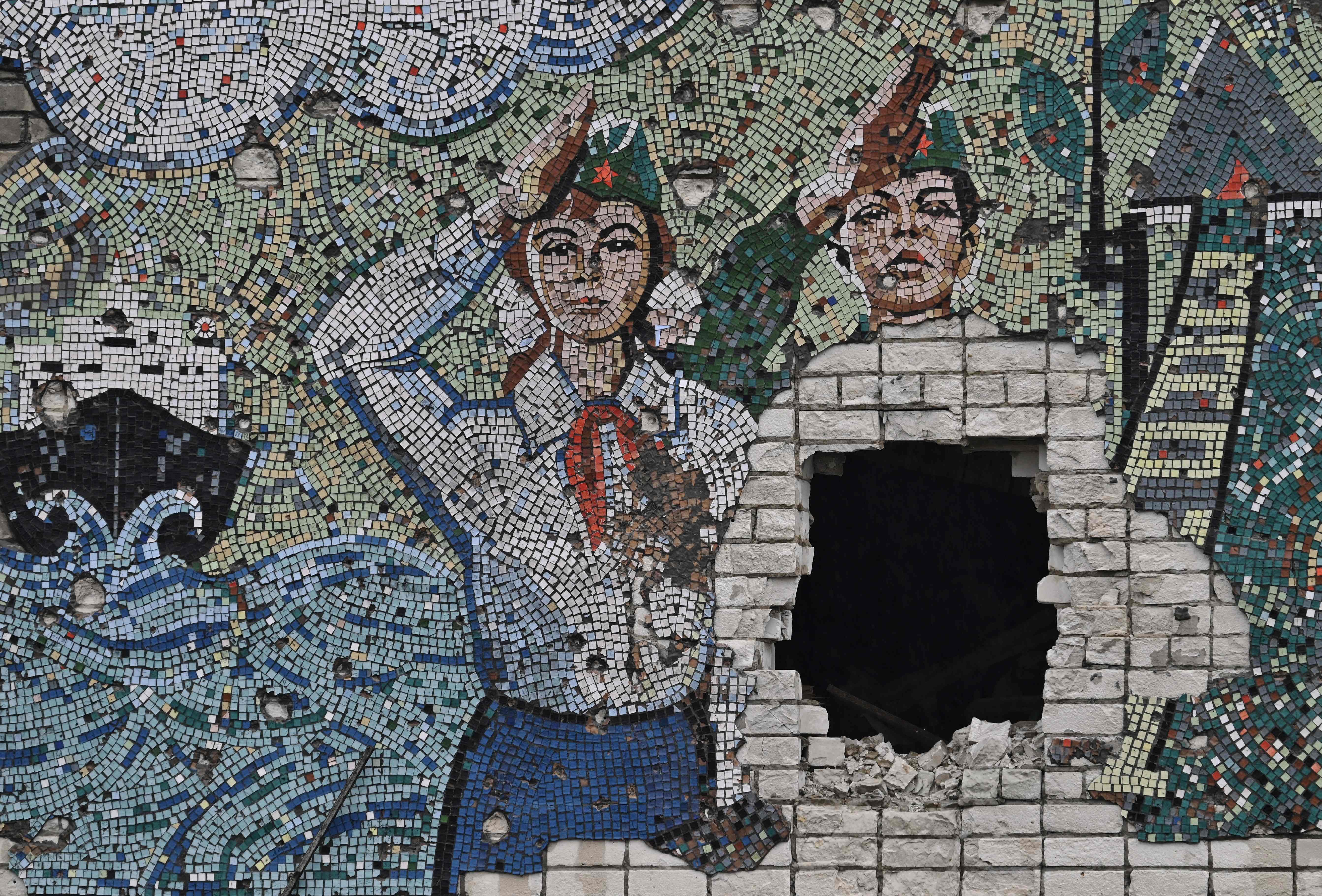 This photograph taken on January 28, 2023, shows a Soviet-era mosaic on a wall of a destroyed school in Oleksandrivka village, Kherson region, amid Russia's military invasion on Ukraine. Credit: AFP Photo