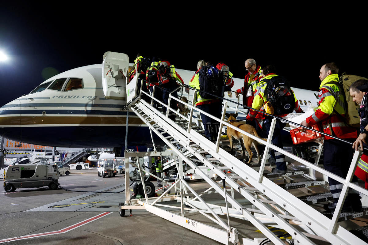 German ISAR rescuers board a plane to help find survivors of the deadly earthquake in Turkey, at Cologne-Bonn airport. Credit: Reuters Photo