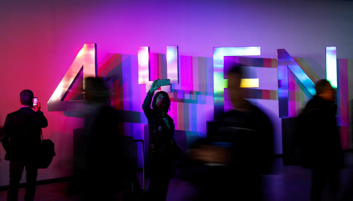 People walk past a sign of 4YFN at the GSMA's 2023 Mobile World Congress (MWC) in Barcelona, Spain. Credit: Reuters Photo