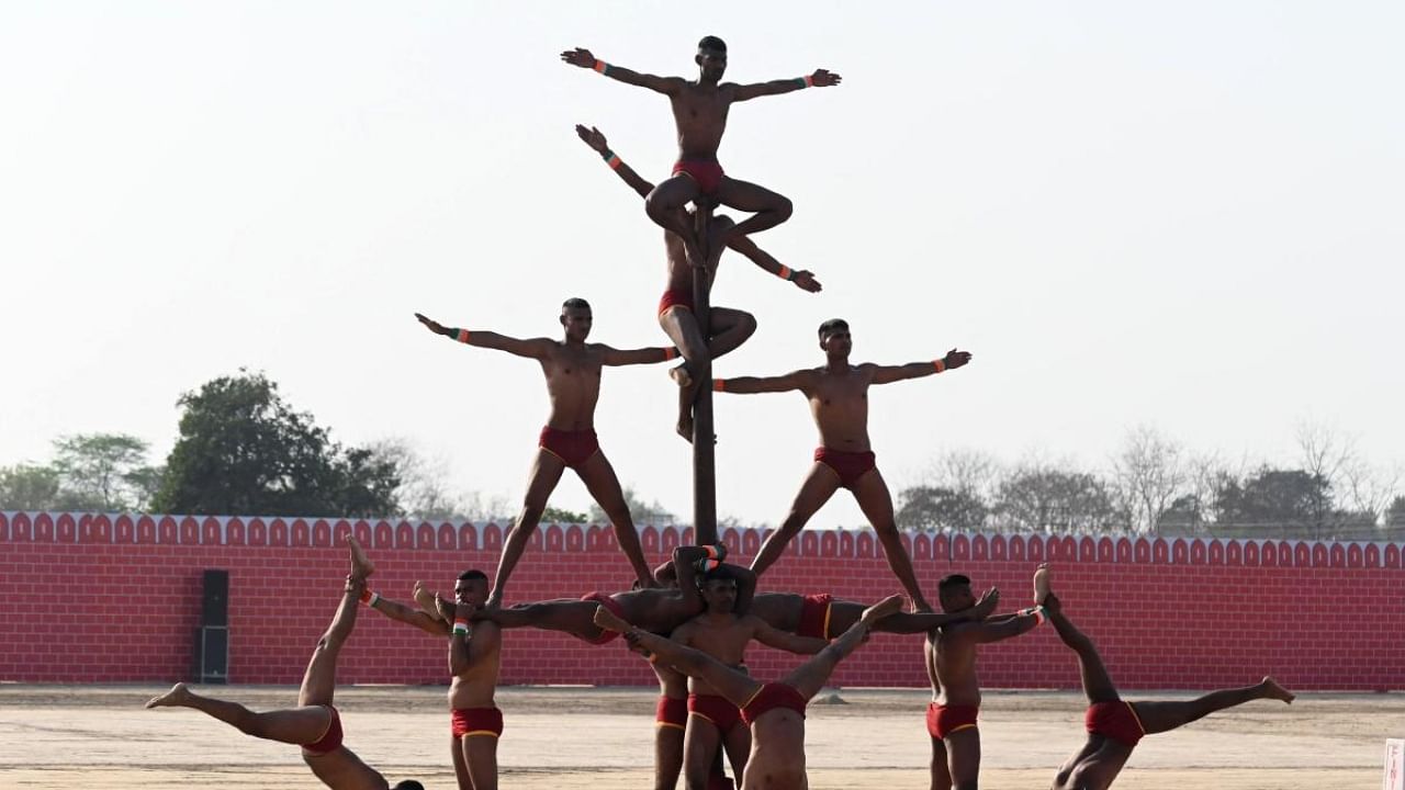 Indian army soldiers perform 'Mallakhamba' during the western command investiture ceremony at a military station on the outskirts of Amritsar. Credit: AFP Photo