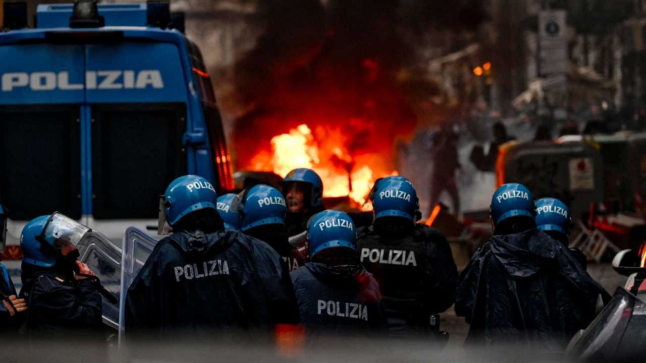 Eintracht Frankfurt fans (Rear) clash with anti-riot police in downtown Naples prior to the UEFA Champions League round of 16. Credit: AFP Photo