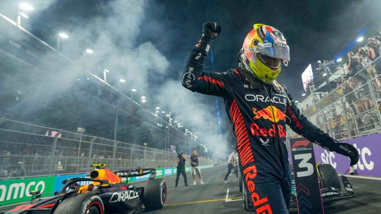 Red Bull Racing's Mexican driver Sergio Perez celebrates after winning the Saudi Arabia Formula One Grand Prix at the Jeddah Corniche Circuit in Jeddah. Credit: AFP Photo