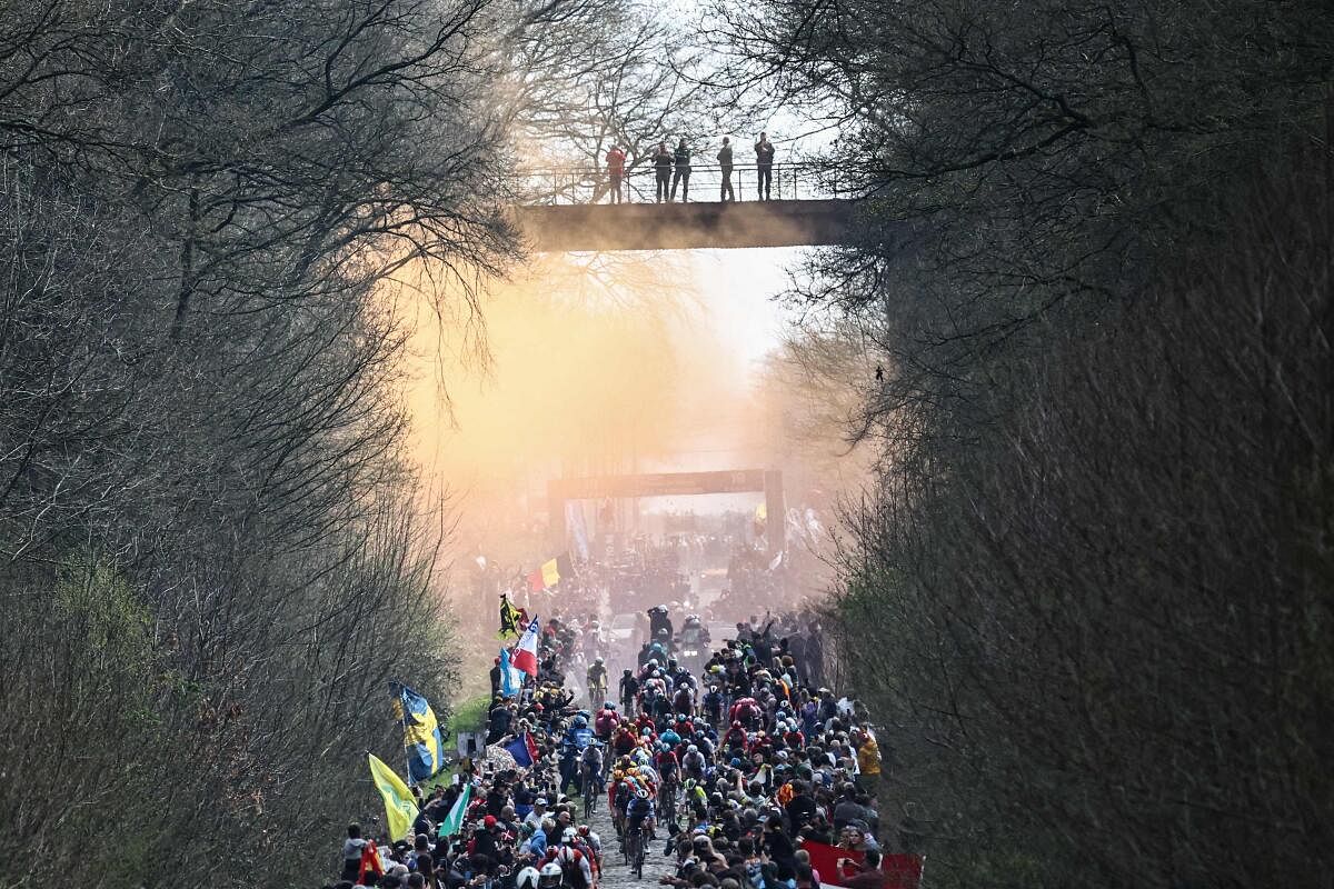 The pack of riders cycles over the Trouee d'Arenberg cobblestone sector during the 120th edition of the Paris-Roubaix one-day classic cycling race, between Compiegne and Roubaix, northern France. Credit: AFP