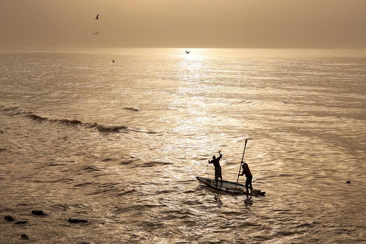 Palestinian fishermen take to the sea at sunset in Gaza city. credit: AFP Photo