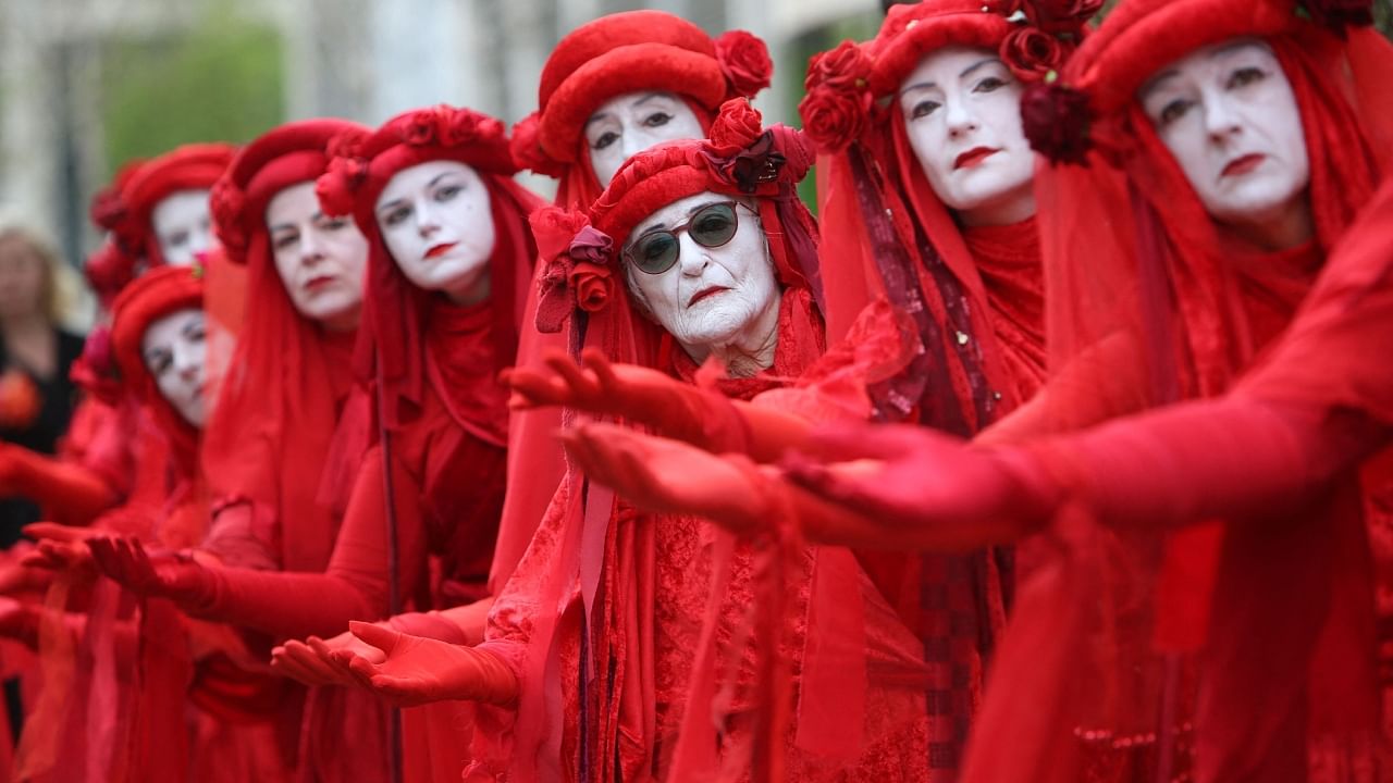 Members of performance troupe Red Rebel Brigade march in central London at a demonstration by the climate change protest group Extinction Rebellion. Credit: AFP Photo